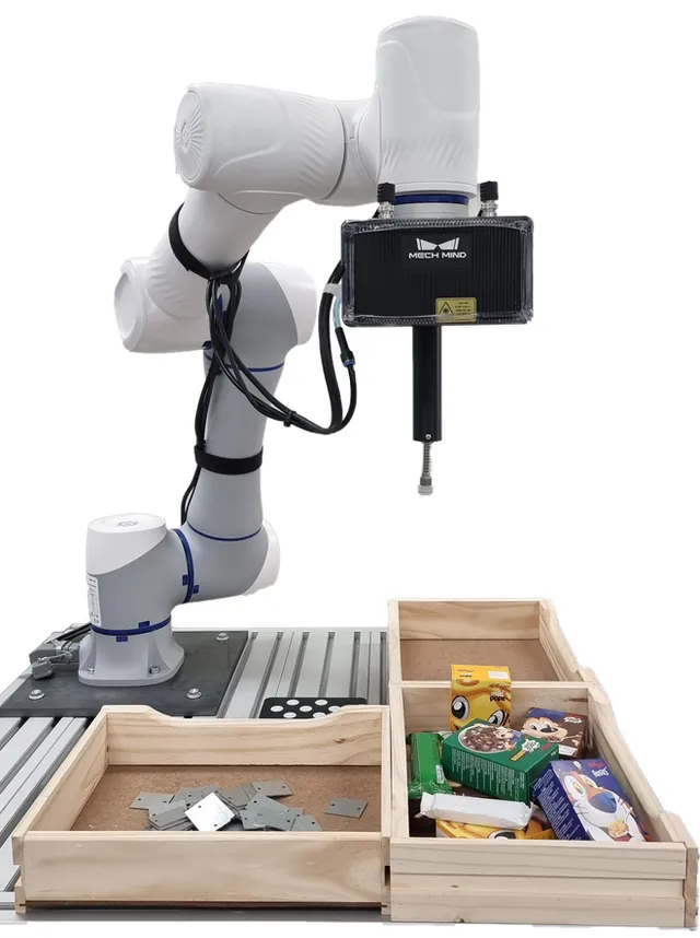 Robotean muntatutako 3D kamera, askotariko piezak dituzten erretiluen gainean.