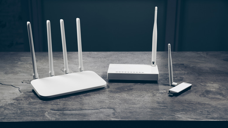 The different routers of differing ages and uses, lined up next to each other.